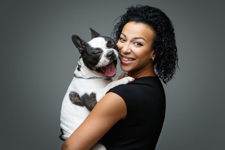 Smiling woman holding a happy French Bulldog in Yorktown
